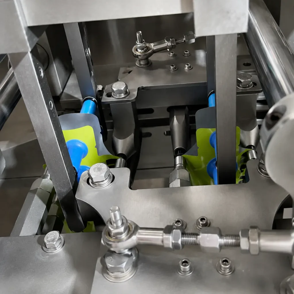 Dual-action vacuum pouch opening system on liquid premade pouch packing machine
